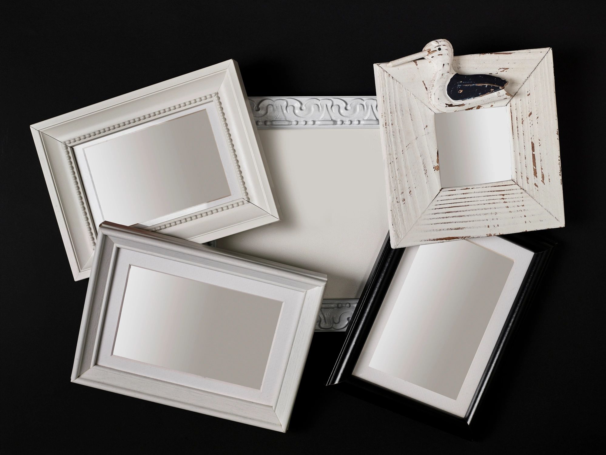 Stack of hollow picture frames on black background